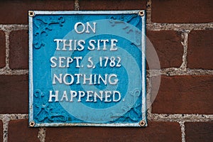 Humour sign on a red brick wall saying that nothing happened on that site on 5th September 1782