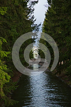 Humpback bridge over the water channel in the park.