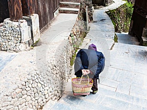 hunched old woman on street in Chengyang village