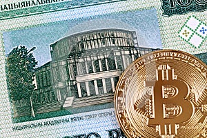 A hundred Belorussian ruble bank note with a golden bitcoin