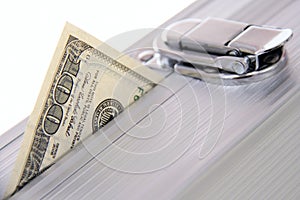 Hundred dollar banknote sticking out suitcase