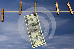 Hundred dollar bill hanging on a clothesline