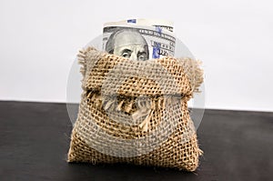 Hundred dollar bills in a bag. Close-up. The concept of business risk, economic crisis, the fall of the economy.