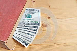 Hundred dollar bills in book
