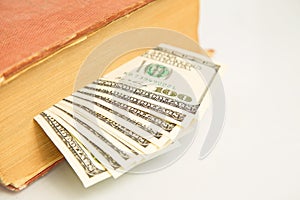 Hundred dollar bills in book