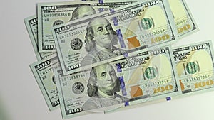 A hundred dollar bills falling down or flying 100 dollar american banknotes. Money rain