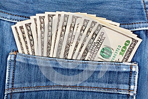 A hundred dollar bills sticking in the back pocket of jeans