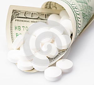 Hundred dollars bill containing white pills