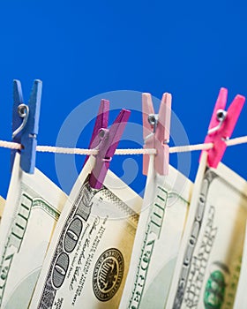 Hundred dollars hanging on a clothesline
