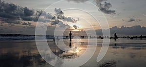 Hundreds of Asian People enjoying the sunset at Canggu beach, Bali