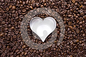 Hundreds of coffee beans with a heart cutter photo