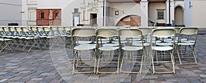 Hundreds of folding chairs are installed on the granite public s