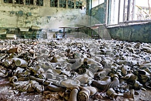 Hundreds of gas masks on classroom floor