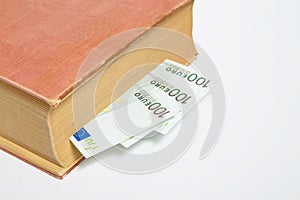 Hundreds od Euros in a book isolated