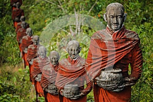 Hundreds of Old Statues of Buddhist Monks Collecting Alms Surround the Win Sein Taw Ya Buddha in Mawlamyine, Myanmar Burma