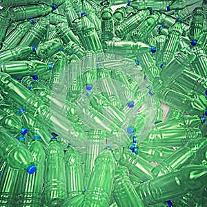 Hundreds of plastic drinking bottles wildly mixed up on a big heap