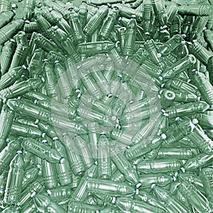 Hundreds of plastic drinking bottles wildly mixed up on a big heap