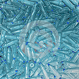 Hundreds of plastic drinking bottles wildly mixed up on a big heap