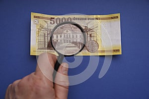 Hungarian 5000 forint paper money banknote. Examine through the magnifying glass.