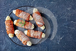 Hungarian chimney cakes on a black serving tray