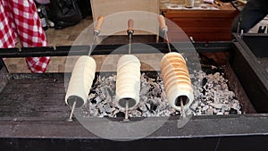 Hungarian cinnamon chimney cake being grilled on the street