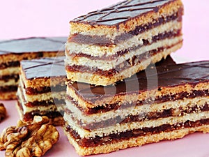 Hungarian Gerbeaud layered cake with walnut and apricot jam filling, covered with chocolate zserbo