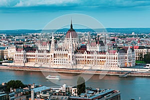 Hungarian Parliament in Budapest buy the Danube river at sunset