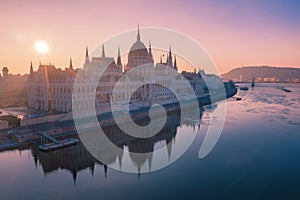 Hungarian Parliament Building on the bank of the river Danube in Budapest at night, aerial photo