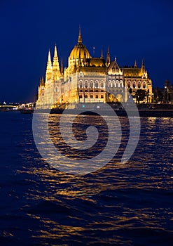 Hungarian Parliament next to the river Danube in Budapest at blue hour after sunset