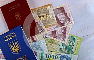 The Hungarian passports and Ukrainian passport with money banknotes forints