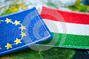 Hungary and european union patches overlapping on europe map, concept of cooperation between union countries, flags of hungary and