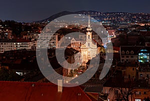 Hungary, evening twilight in Budapest, church against the background of night city lights, cityscape