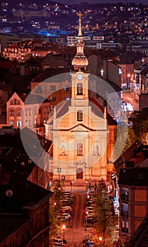 Hungary, evening twilight in Budapest, church against the background of night city lights, cityscape