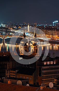 Hungary, evening twilight in Budapest, church on the background of night city lights, cityscape