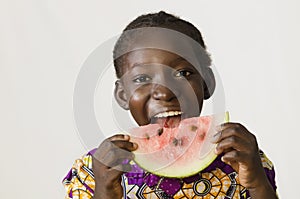 Hunger symbol - African child enjoying some watermelon - isolate