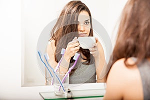 Hungover girl drinking some coffee photo