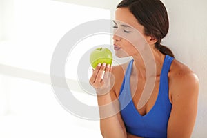 Hungry beautiful woman kissing an apple