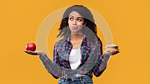 Hungry Black Lady Holding Burger And Apple Fruit