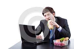 Hungry businessman eating a sadwich