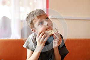 Hungry child eating bread