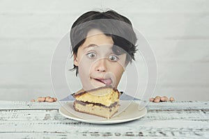 Hungry child eating piece of cake