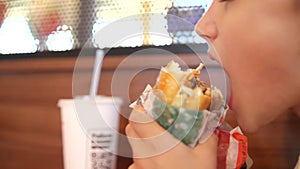 hungry child eats a burger with appetite. boy eating a big burger