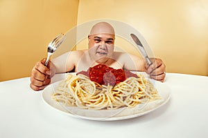 Hungry fat man eating spaghetti