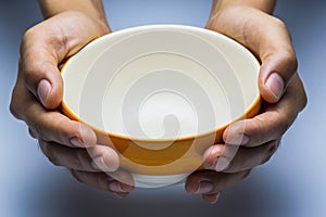 A hungry female holding an empty bowl.