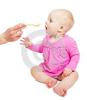 Hungry girl eats porridge
