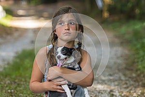 A Hungry Homeless Abandoned Runaway Child Looks For Food And Shelter With Her Little Dog