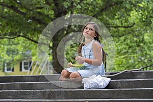 A Hungry Homeless Abandoned Runaway Child Looks For Food And Shelter While Holding An Empty Plate Of Food