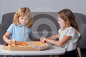 Hungry kids eating pizza. Children preparing to eat fresh pizza.
