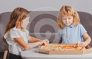 Hungry kids eating pizza. Children preparing to eat fresh pizza.