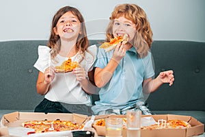 Hungry kids eating pizza. Little girl and boy eat pizza.